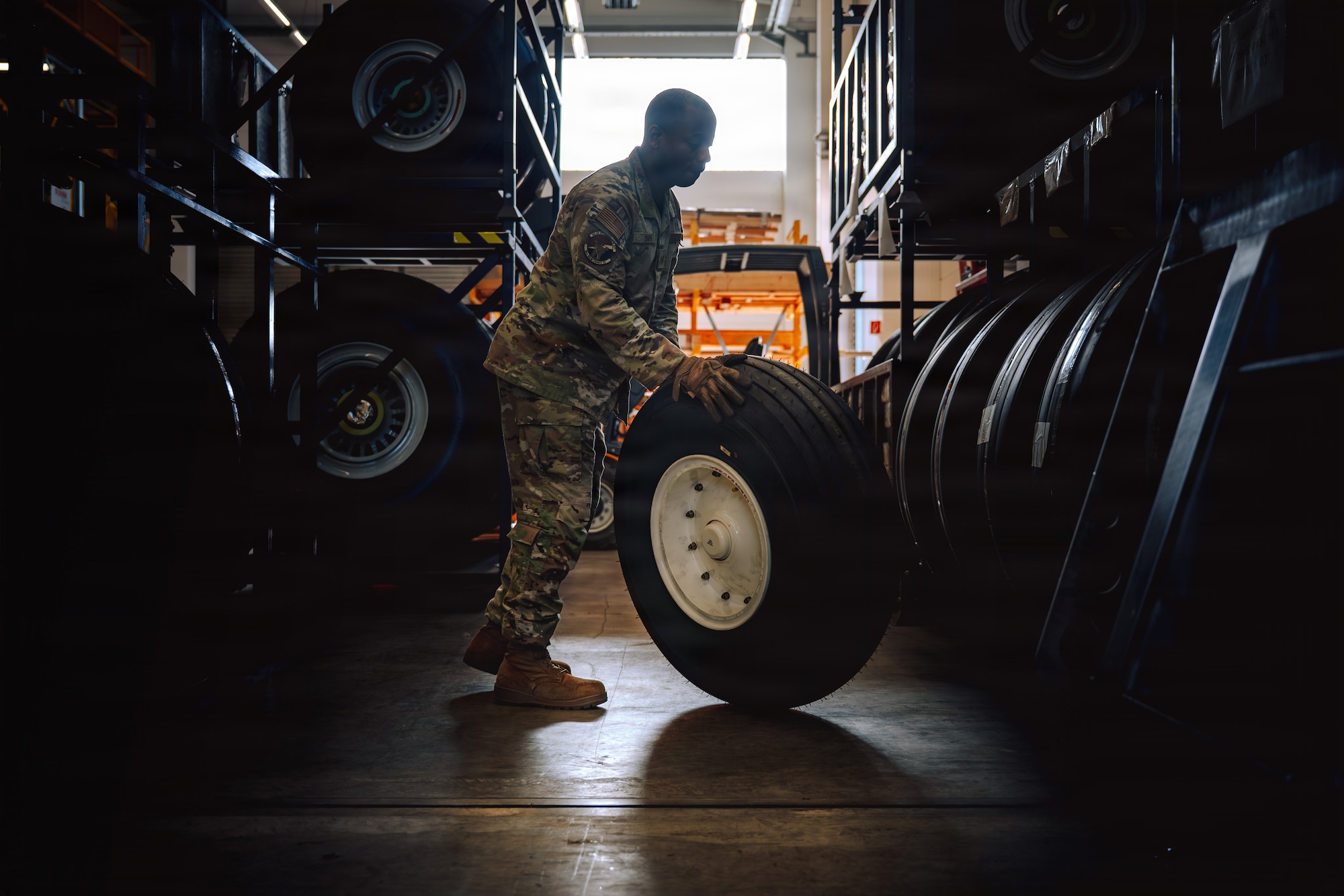 U.S. Air Force Tech Sgt. Christopher Smith, 86th Maintenance Squadron wheel and tire non-commissioned officer in charge, rolls a tire off the rack at Ramstein Air Base, Germany, May 29, 2026.