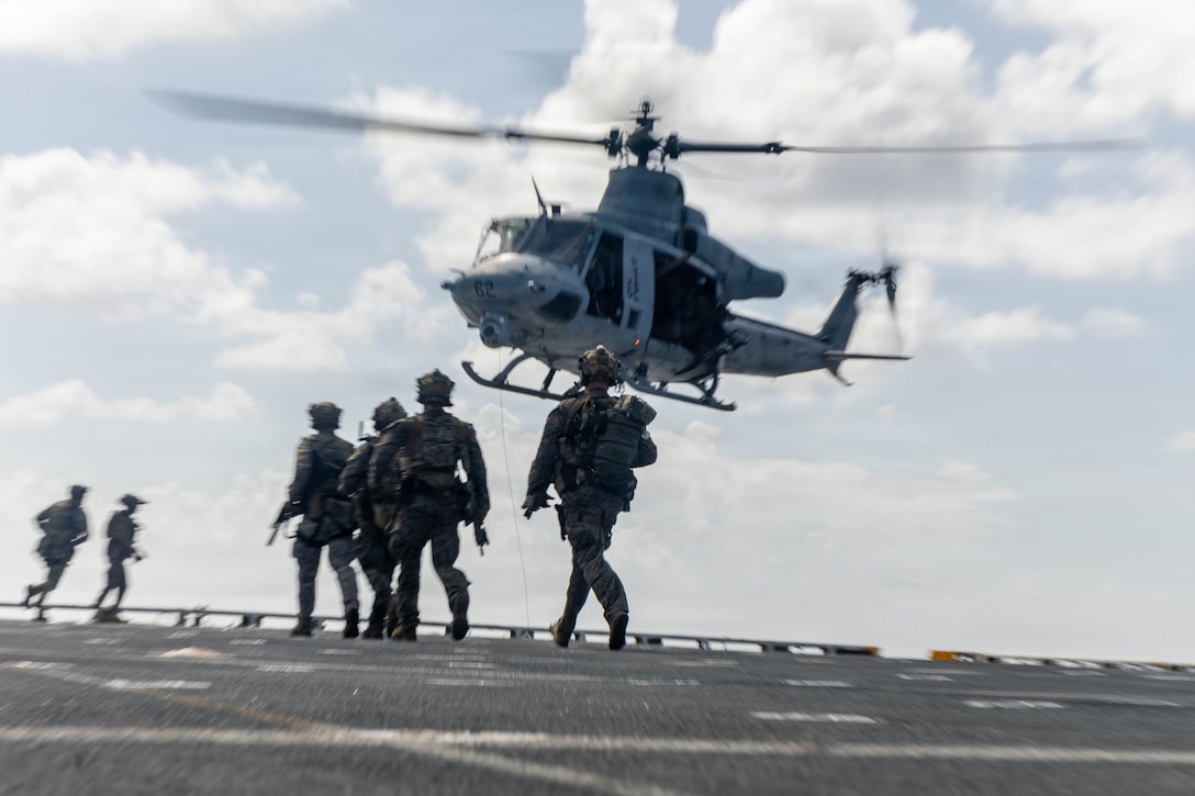 U.S. Marines with Maritime Raid Force, Littoral Combat Force-24, approach a UH-1Y Venom helicopter assigned to Marine Medium Tiltrotor Squadron (VMM) 365 (Reinforced), 24th MEU, during a Maritime Interdiction Operation Full Mission Profile rehearsal aboard San Antonio-class amphibious transport dock USS Fort Lauderdale (LPD 28) while underway in the Caribbean Sea, May 22, 2026. U.S. military forces are deployed to the U.S. Southern Command area of responsibility in support of Operation SOUTHERN SPEAR, Department of War-directed operations, and the president’s priorities to disrupt illicit drug trafficking, deter malign actors and protect the homeland through continuous presence. (U.S. Marine Corps photo)