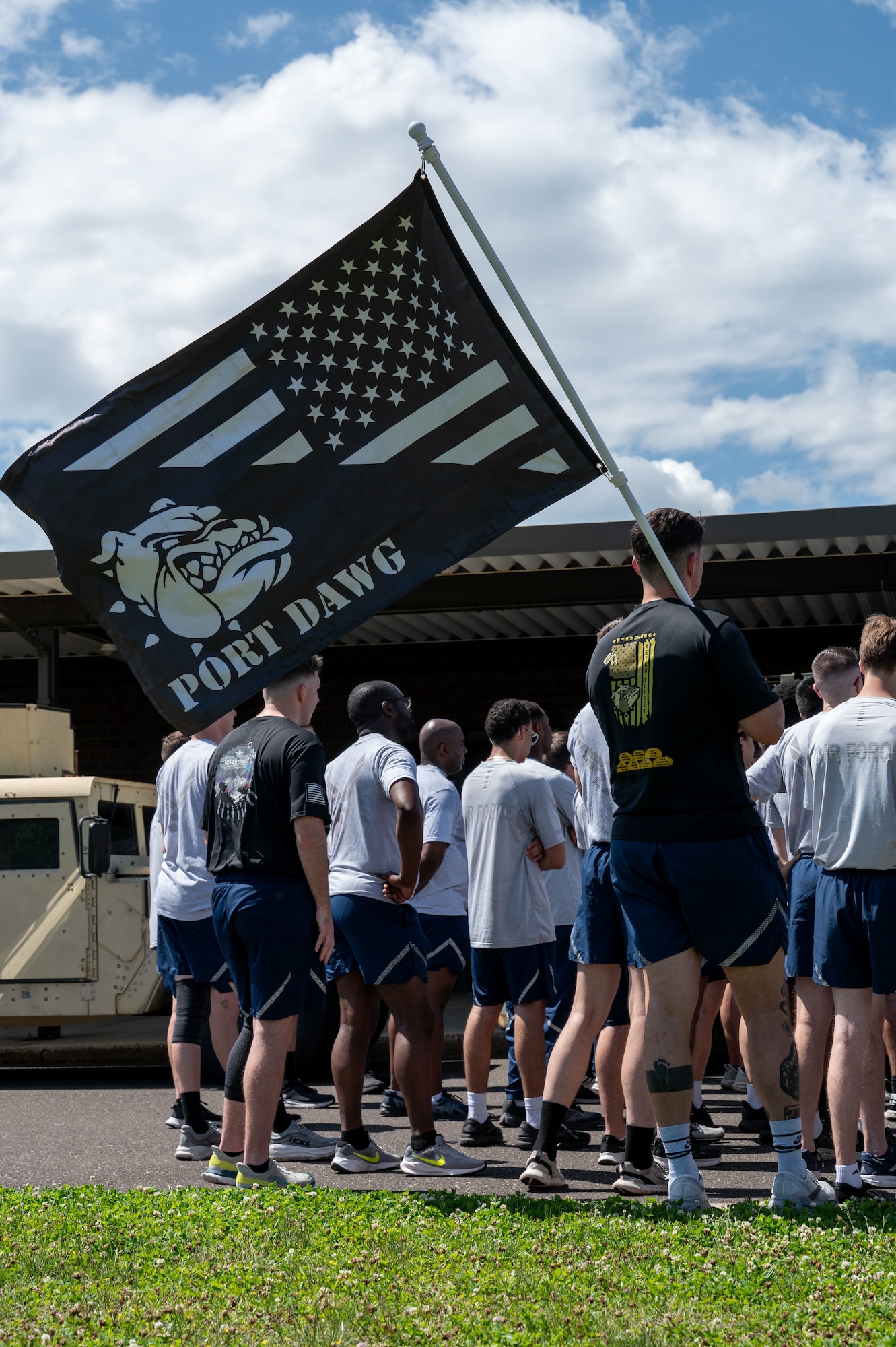 A U.S. Air Force Port Dawg flag is carried during the 13th annual Port Dawg memorial run at Joint Base McGuire-Dix-Lakehurst, N.J., May 28, 2026.