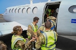New Hampshire National Guard medical personnel and Cabo Verde Armed Forces Medical Unit members load a simulated patient aboard a C-12 Huron multipurpose aircraft assigned to the Cabo Verde Coast Guard Air Squadron during an aeromedical knowledge exchange in Praia, Cabo Verde, May 22, 2026. The hands-on engagement helped participants examine coordination, communication and patient movement considerations in a smaller-aircraft environment. Photo by Staff Sgt. Elliot Boutin.