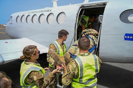 New Hampshire National Guard medical personnel and Cabo Verde Armed Forces Medical Unit members load a simulated patient aboard a C-12 Huron multipurpose aircraft assigned to the Cabo Verde Coast Guard Air Squadron during an aeromedical knowledge exchange in Praia, Cabo Verde, May 22, 2026.