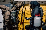 U.S. Soldiers and Airmen with the Washington National Guard’s 10th Homeland Response Force decontaminate search and recovery teams following a chemical tank rupture at the Nippon Dynawave pulp and paper mill in Longview, Washington, May 28, 2026. Mass decontamination experts, fatality search and recovery teams, and medical personnel with the Washington National Guard have been on-site since May 26, 2026, to assist in managing the chemical hazards on site. Photo by Sgt. 1st Class Adeline Witherspoon.