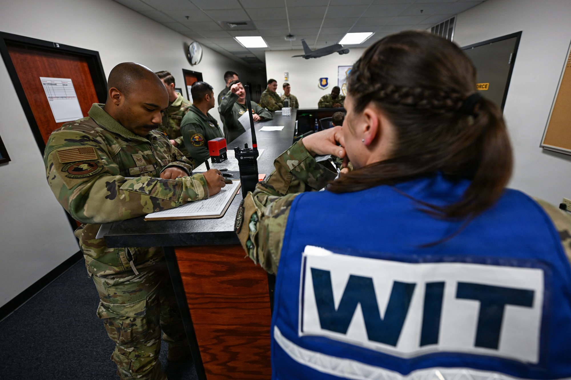 A member of the wing inspection team evaluates Airmen during a nuclear operational response exercise at McConnell Air Force Base, Kansas, Feb. 7, 2026. WIT members inspect and evaluate operations during exercises to provide instruction and improve overall processes. (U.S. Air Force photo by Senior Airman Amelio Brown)