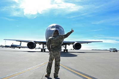 McConnell Airmen marshal a KC-46 Pegasus during a nuclear operational response exercise at McConnell Air Force Base, Kansas, Feb. 7, 2026. Once the exercise members were on board the aircraft, they simulated the taxi and take off procedures. (U.S. Air Force photo by Senior Airman Amelio Brown)