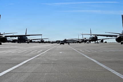 Alert vans arrive at the flightline during a nuclear operational response exercise at McConnell Air Force Base, Kansas, Feb. 7, 2026. Each van had a designated spot in which the members would exit and board an awaiting KC-46 Pegasus. (U.S. Air Force photo by Senior Airman Amelio Brown)