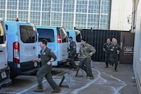 Team McConnell members rush to alert vans during a nuclear operational response exercise at McConnell Air Force Base, Kansas, Feb. 7, 2026. Following the alert signal, members hurried to the vans that transported them from the facility to the flightline. (U.S. Air Force photo by Senior Airman Amelio Brown)