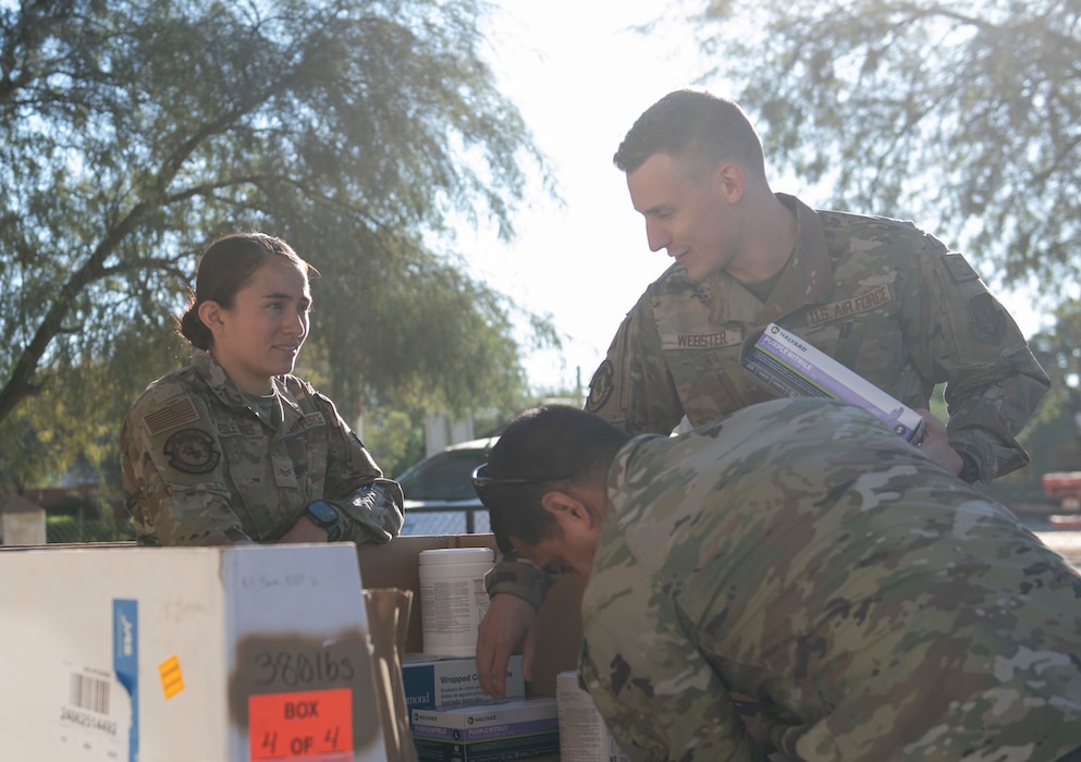 Image of Airmen working together with supplies.