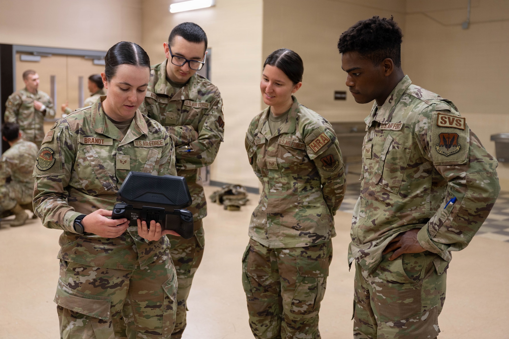 Airmen fly a drone.