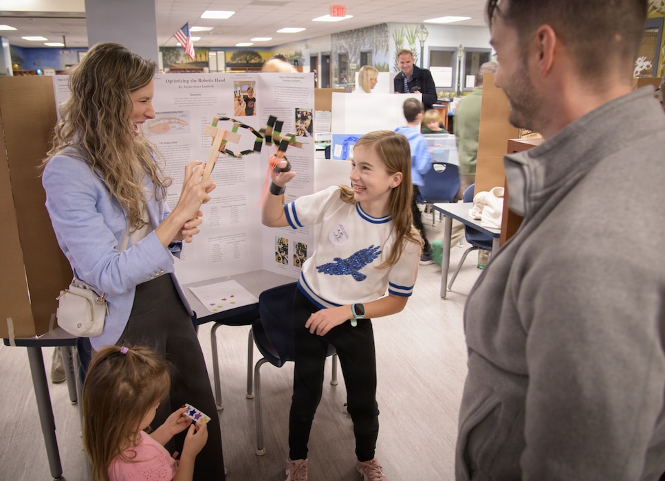 Ashlee Landreth, Expeditionary Warfare Department Head at Naval Information Warfare Center Atlantic, engaging with participants at a community STEM event in Charleston.