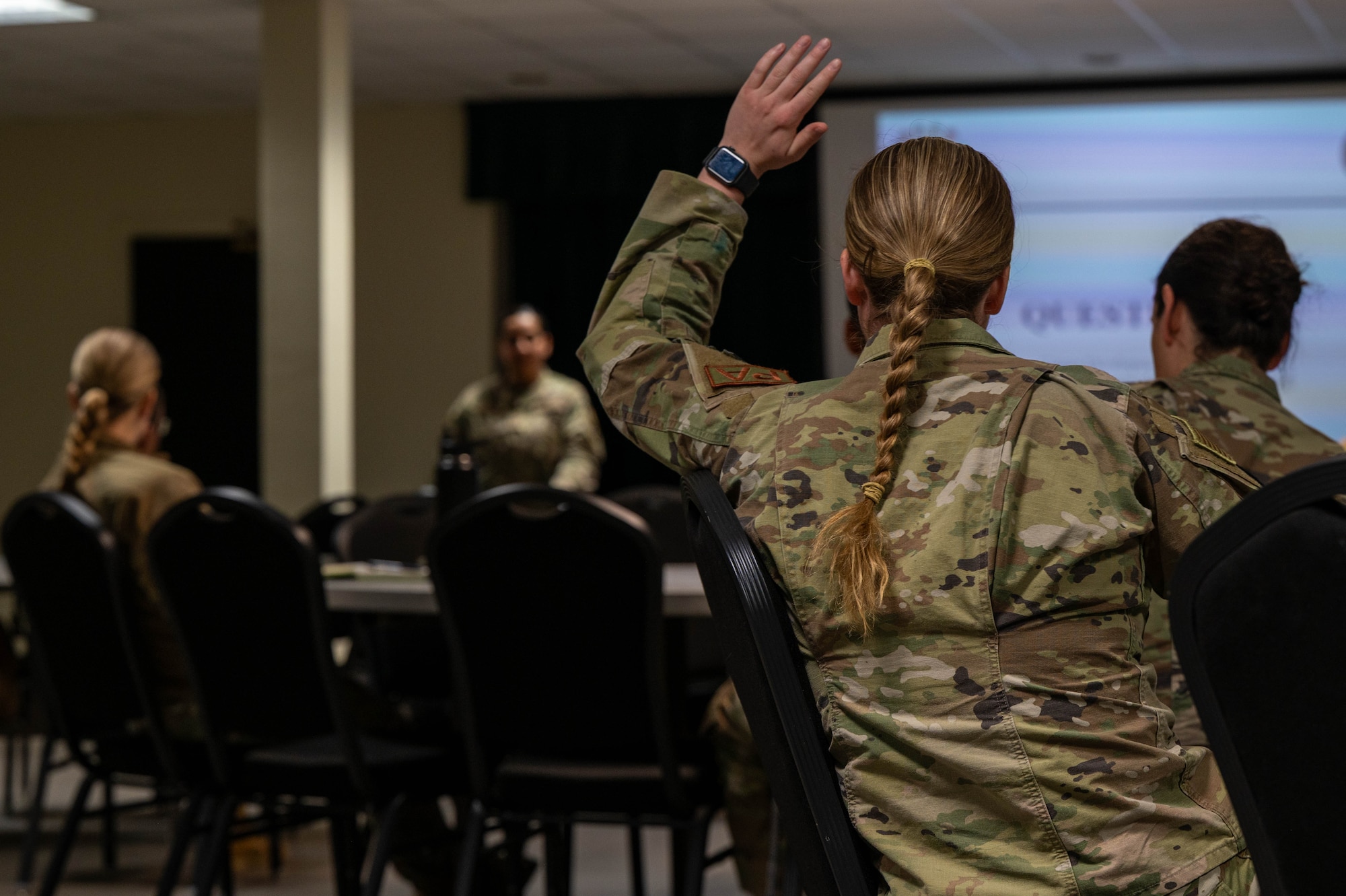 Airmen listen to a brief on assignment and Permanent Change of Station processes during the Warrior Action Team’s professional development events at Laughlin Air Force Base, Texas, Feb. 24, 2026. Through monthly group-led events, the WAT builds esprit de corps, fosters connections to the larger Air Force mission, and instills a culture of health betterment across the Wing. (U.S. Air Force photo by Senior Airman Jarrett Smith)