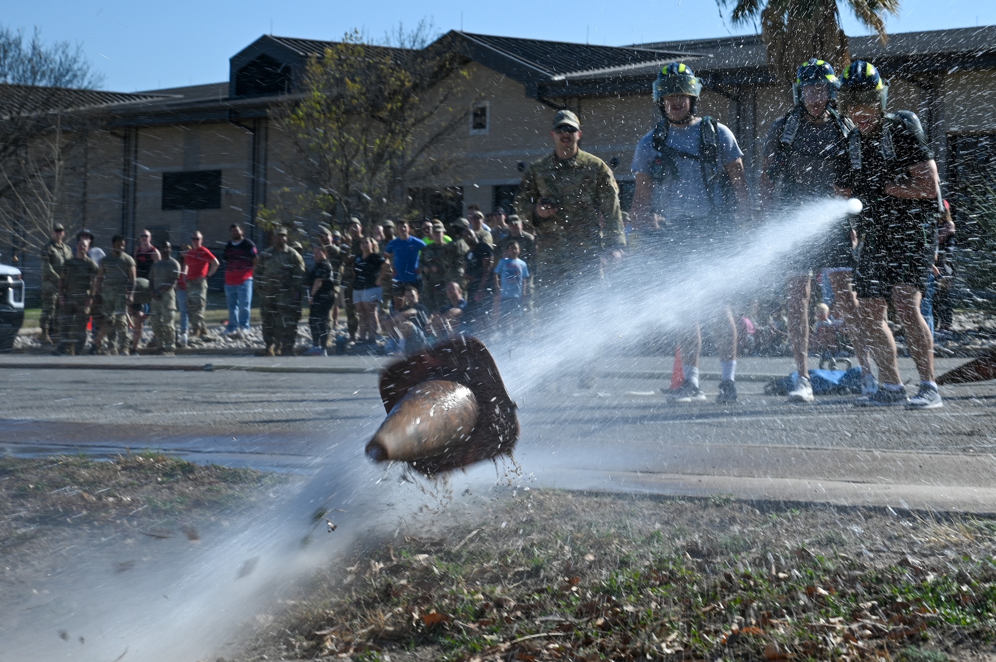 Participants in one the Warrior Action Team’s professional development events spray a cone with a firehose during the firefighter challenge at Laughlin Air Force Base, Texas, Feb. 27, 2026. This month's WAT Professional Development events were hosted by the 47th Mission Support Group, which included briefs on cyber security and assignments, as well as the excellence in competition pistol shooting match and fire fighter challenge. (U.S. Air Force photo by Airman 1st Class Kylie Rabb)