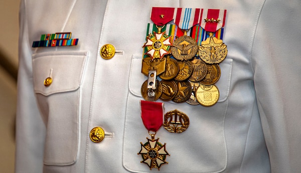 The medals and ribbons of Naval Medical Forces Atlantic Deputy Commander, Capt. Chad McKenzie,  a native of Bellefontaine, Ohio, displayed during his retirement ceremony on board Naval Support Activity (NSA) Hampton Roads - Portsmouth Annex, Portsmouth, Virginia, May 29, 2026. McKenzie served the Navy for nearly 30 years of dedicated service across 16 commands and helped advance Navy Medicine’s operational readiness and expeditionary medical capabilities in support of Fleet, Marine Corps, and joint force requirements. (U.S. Navy photo by Mass Communication Specialist 2nd Class Levi Decker)