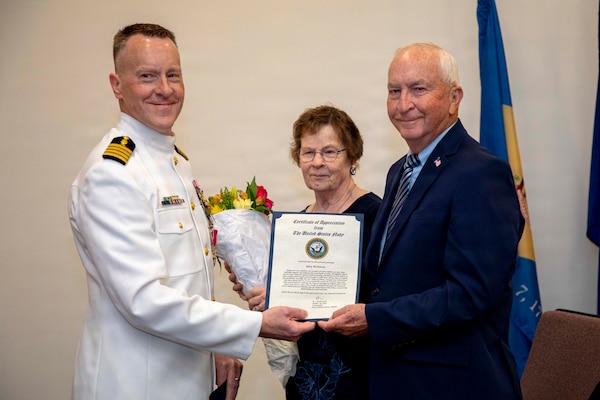 Naval Medical Forces Atlantic Command Deputy Commander, Capt. Chad McKenzie,  a native of Bellefontaine, Ohio, presents his family with certificates of appreciation during his retirement ceremony on board Naval Support Activity (NSA) Hampton Roads - Portsmouth Annex, Portsmouth, Virginia, May 29, 2026. McKenzie served the Navy for nearly 30 years of dedicated service across 16 commands and helped advance Navy Medicine’s operational readiness and expeditionary medical capabilities in support of Fleet, Marine Corps, and joint force requirements. (U.S. Navy photo by Mass Communication Specialist 2nd Class Levi Decker)