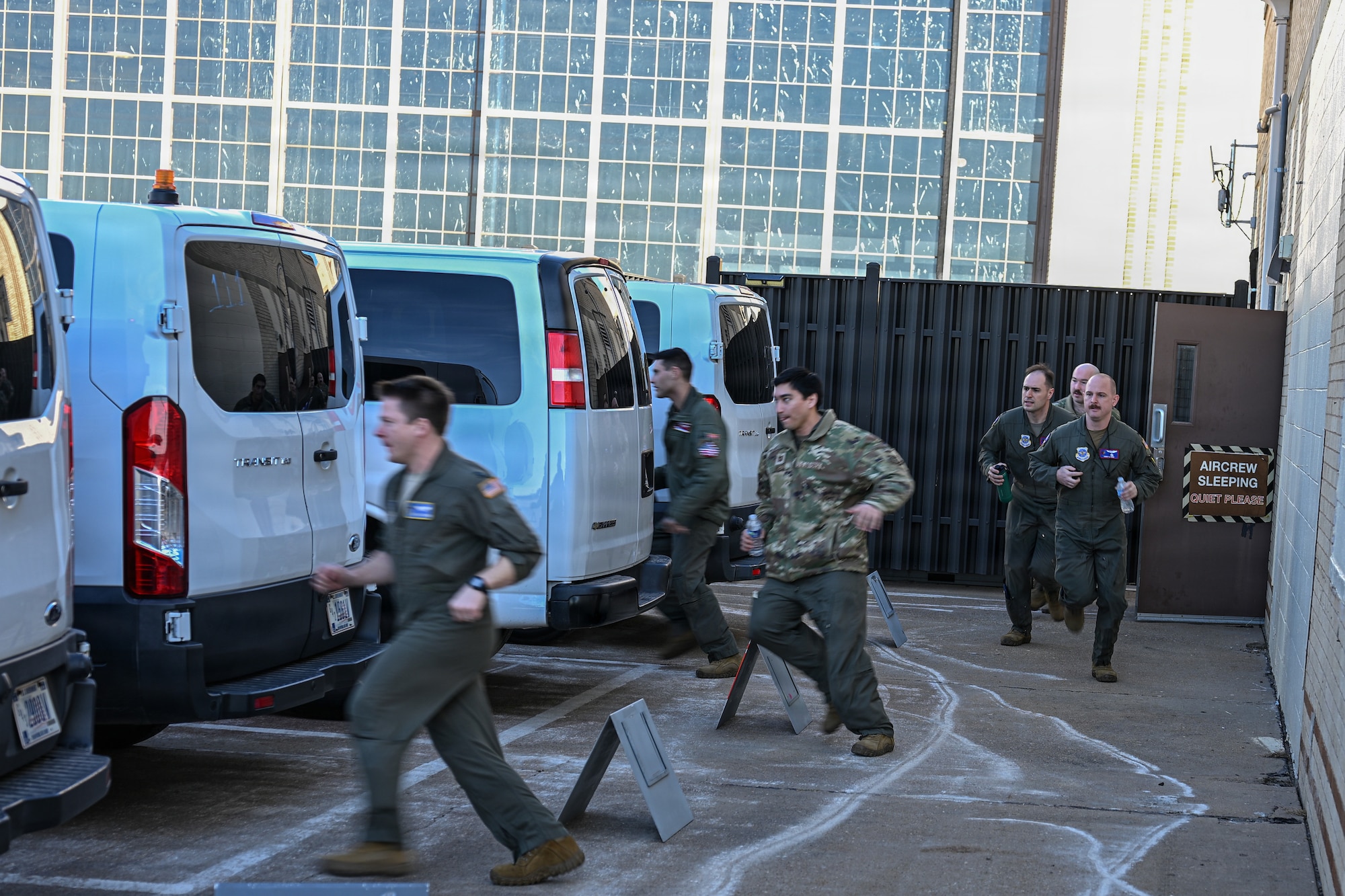 Team McConnell members rush to alert vans during a nuclear operational response exercise at McConnell Air Force Base, Kansas, Feb. 7, 2026. Following the alert signal, members hurried to the vans that transported them from the facility to the flightline. (U.S. Air Force photo by Senior Airman Amelio Brown)