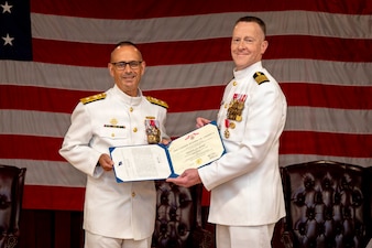Rear Adm. Robert Hawkins, commander, Naval Medical Forces Atlantic (NMFL), presents a Legion of Merit to Capt. Chad McKenzie, deputy commander, NMFL and a native of Bellefontaine, Ohio, during his retirement ceremony on board Naval Support Activity (NSA) Hampton Roads - Portsmouth Annex, Portsmouth, Virginia, May 29, 2026. McKenzie served the Navy for nearly 30 years of dedicated service across 16 commands and helped advance Navy Medicine’s operational readiness and expeditionary medical capabilities in support of Fleet, Marine Corps, and joint force requirements.  (U.S. Navy photo by Mass Communication Specialist 2nd Class Levi Decker)