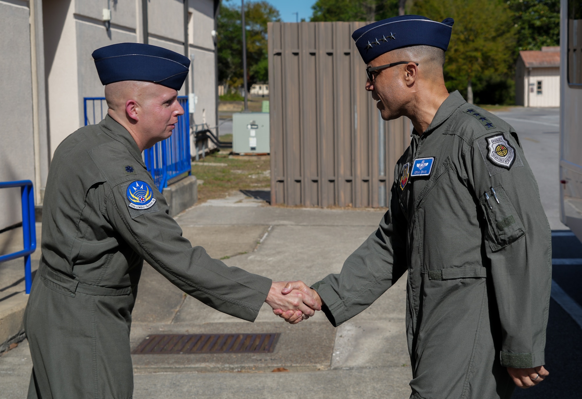 two USAF Airmen shake hands