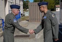 two USAF Airmen shake hands