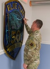 USAF Airman signs BLUE FLAG metal art