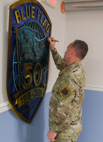 USAF Airman signs BLUE FLAG metal art
