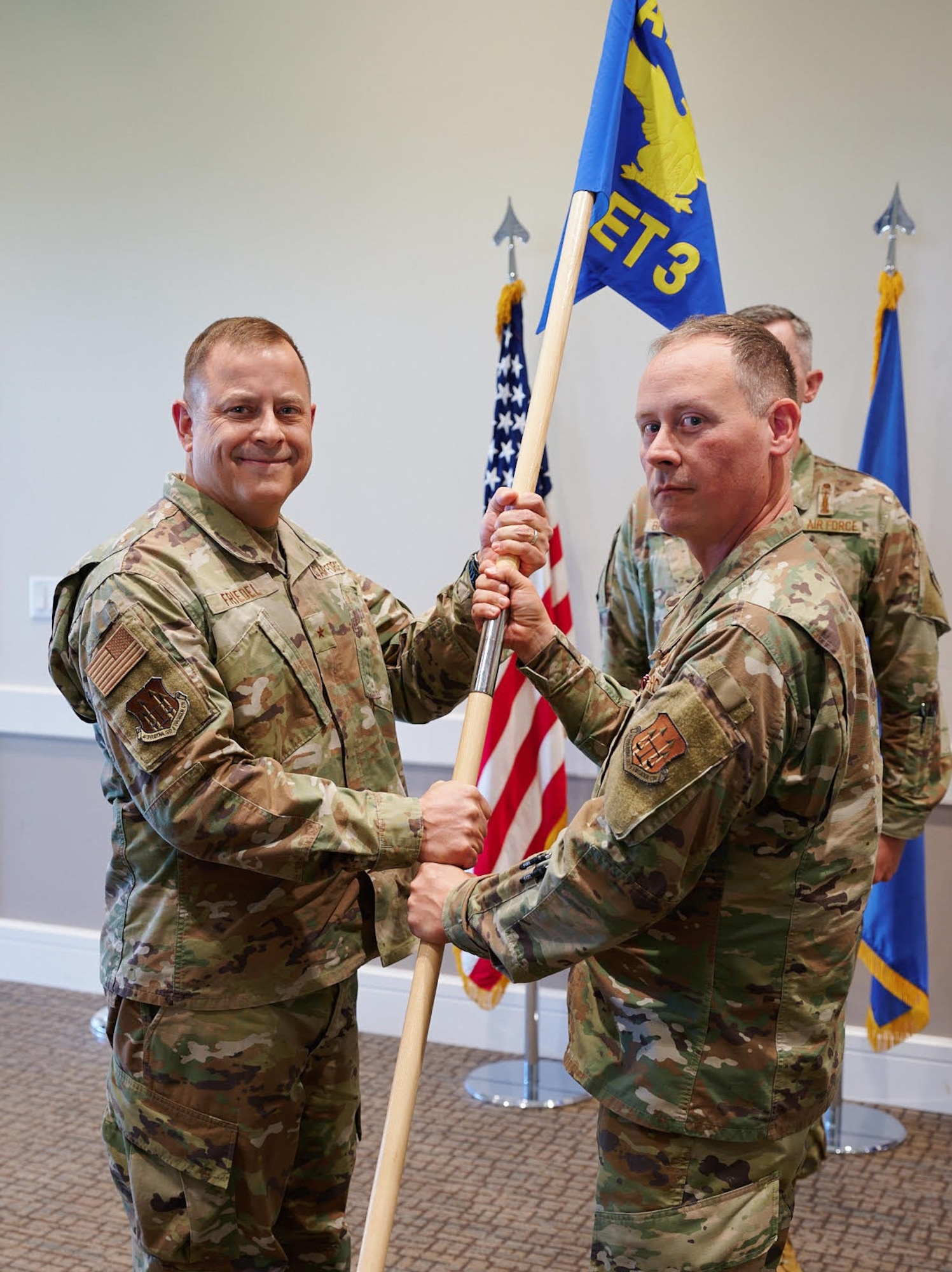 (Right) Col. Adam T. Rector relinquishes command of Air Force Operational Test and Evaluation Center Detachment 3 to AFOTEC Commander Brig. Gen. Jesse J. Friedel during a Change of Command ceremony May 28, 2026. Rector will become the 91st Maintenance Group Commander at Minot AFB, N.D.