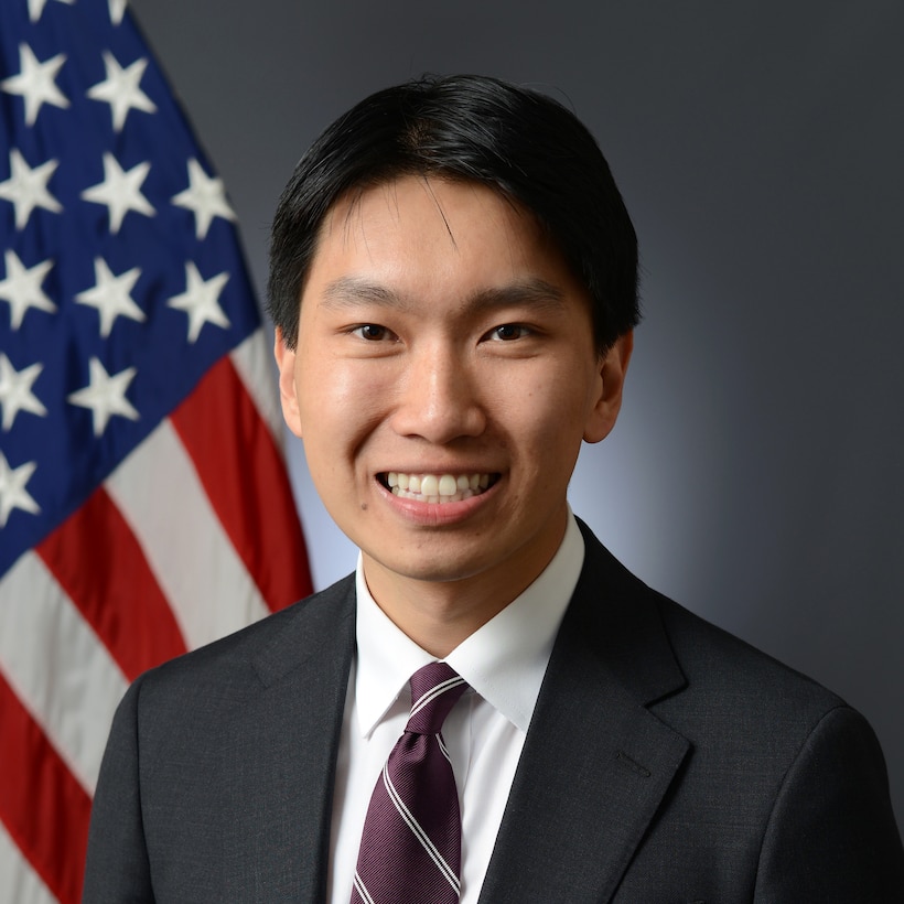 Official Bio Photo with US flag in background