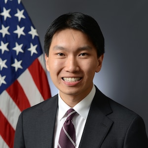 Official Bio Photo with US flag in background