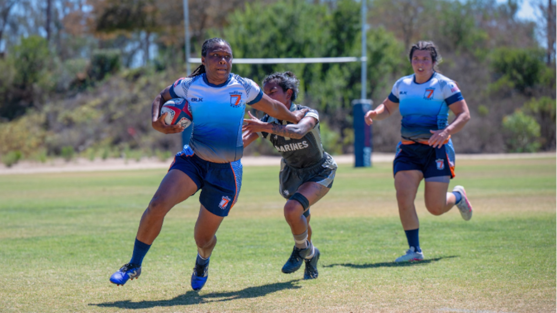 Petty Officer 2nd Class Ra’Shaun Coker surges past a Marine defender after gaining possession during the 6th annual Armed Forces Women’s Rugby Championship in Chula Vista, California, Sept., 2025. Coker is known for her dedication and leadership on and off the field.