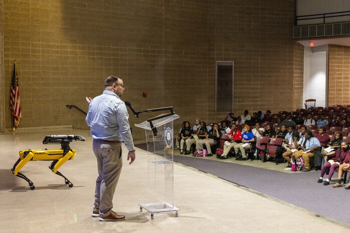 BALTIMORE (May 20, 2026) – Dr. Shane Wines, a member of the Naval Surface Warfare Center, Carderock Division’s Strategic Education Outreach Team, engages with students during a Tech Day event at the SEED School of Baltimore. The outreach team visited the school to provide hands-on robotics demonstrations to 158 middle school students, aiming to spark curiosity and inspire the next generation of science, technology, engineering, and mathematics (STEM) professionals in naval engineering. (U.S. Navy photo by Aaron Thomas