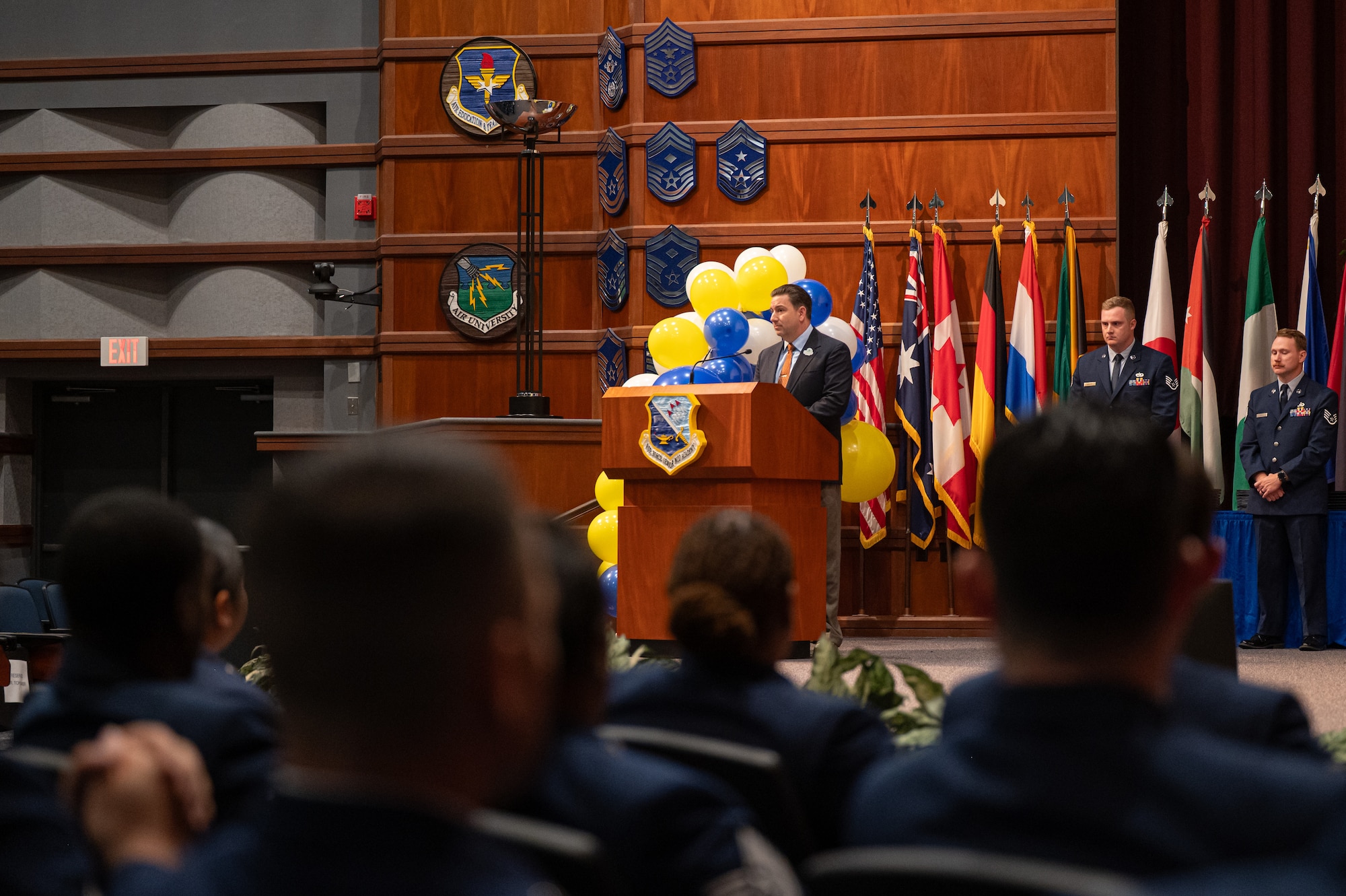 Retired U.S. Air Force Master Sgt. Tom Baker, 42d Force Support Squadron education specialist, gives a speech during a Community College of the Air Force Graduation Ceremony at Gunter Annex, Alabama, May 28, 2026.