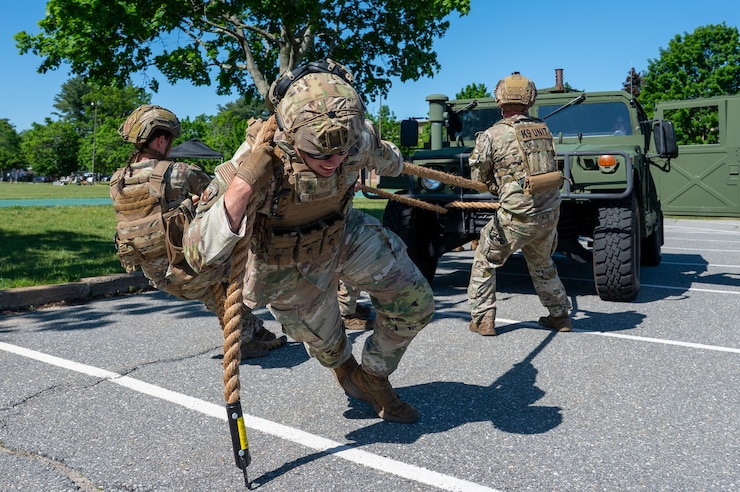 Image of Airmen pulling Humvee.