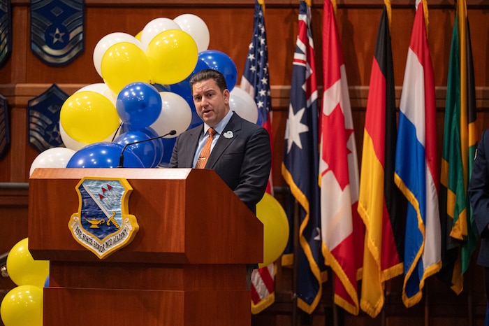 Retired U.S. Air Force Master Sgt. Tom Baker, 42d Force Support Squadron education specialist, gives a speech during a Community College of the Air Force Graduation Ceremony at Gunter Annex, Alabama, May 28, 2026.