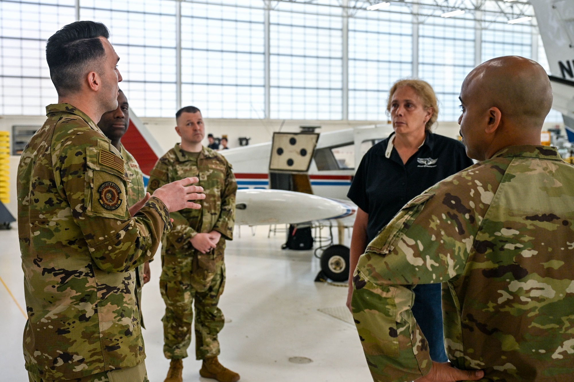 Senior Master Sgt. Jared Locavara, recruiting flight chief at Westover Air Reserve Base, Massachusetts, discusses the symbiotic relationship of military aircraft training for Air Force maintainers and civilian aviation maintenance can strengthen each other's skill sets to Chief Master Sgt. Armil Rucker, senior enlisted leader, 350th Recruiting Squadron, Joint Base McGuire-Dix-Lakehurst, New Jersey, Chief Master Sgt. Aaron Fowler, 350RCS accessions superintendent, Dawn Graham, department head at Connecticut Aero Tech School for Aviation Maintenance Technicians, Hartford, Connecticut, and U.S. Air Force Chief Master Sgt. Israel Nuñez, senior enlisted advisor to the Chief of Air Force Reserve, the Pentagon, Arlington, Virginia, and the Command Chief Master Sgt. of Air Force Reserve Command, Robins Air Force Base, Georgia, May 7, 2026, Hartford, Connecticut. Nuñez, teamed up with AFR recruiters from the 350RCS to share the "Reserve Advantage" message that offers benefits, flexibility and a life of service, with aircraft maintenance students at CT Aero Tech. (U.S. Air Force photo by Master Sgt. Della Creech)