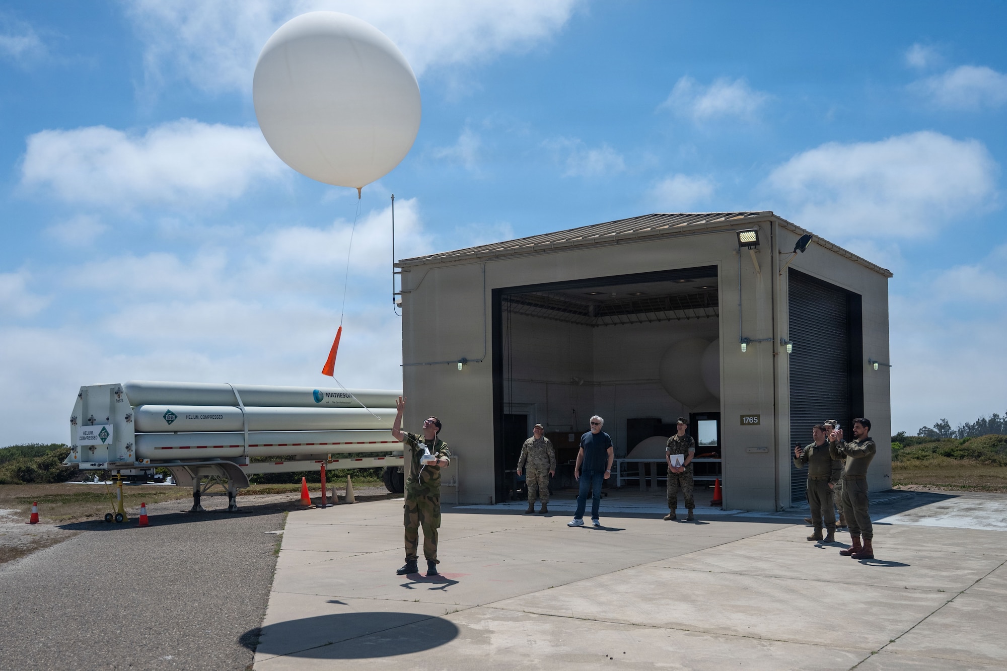 a person releases a weather balloon into the sky