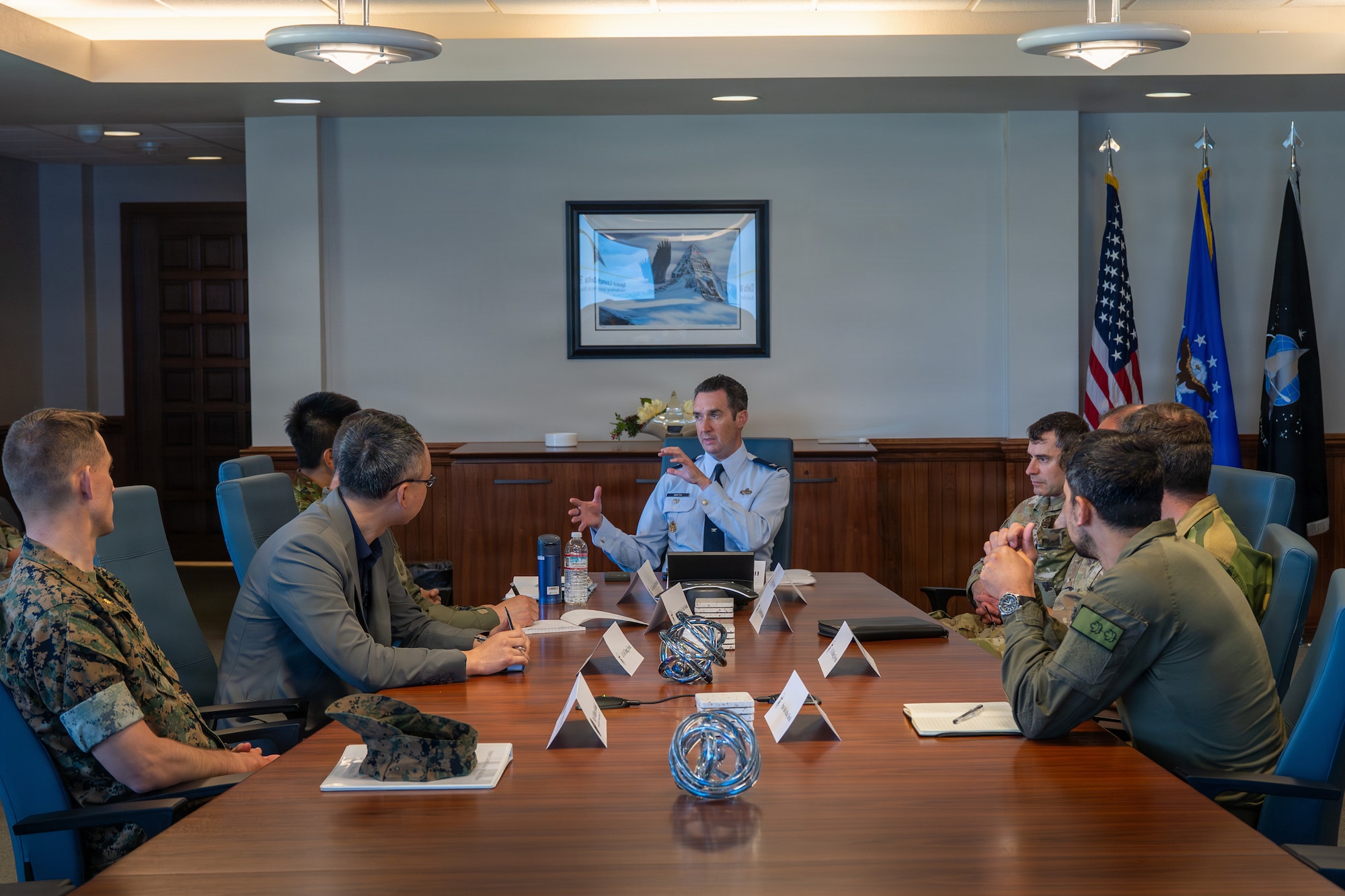 a group of people sit at a table and have a conversation