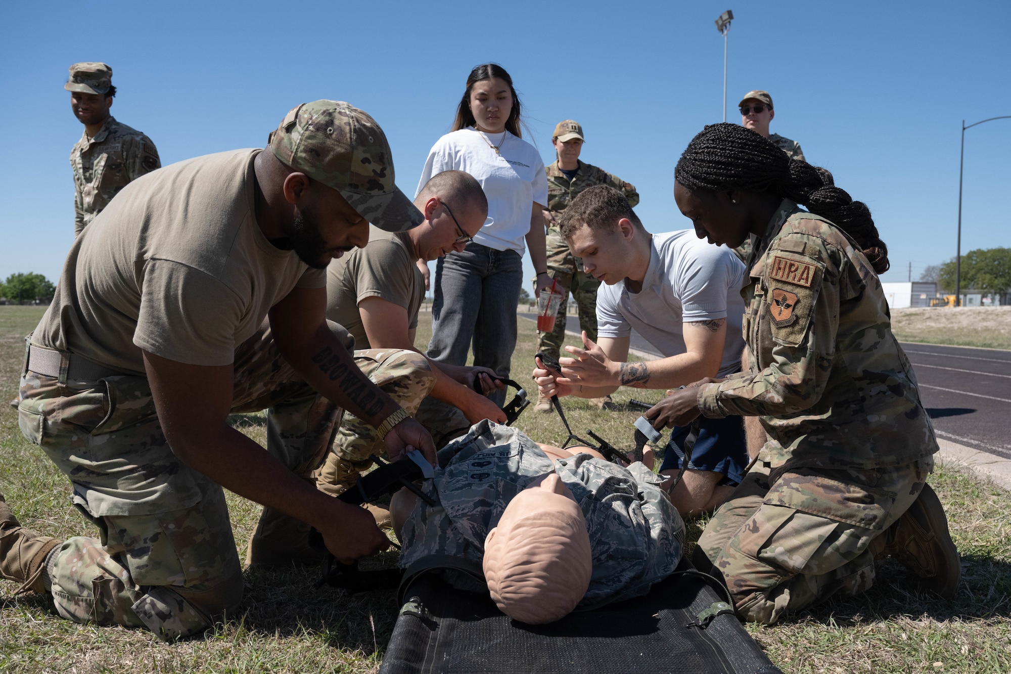 U.S. Air Force Airmen assigned to the 47th Force Support Squadron apply tourniquets to a mannequin during the Tactical Combat Casualty Care (TCCC) Rodeo at Laughlin Air Force Base, Texas, March 20, 2026. Administering tourniquets are vital in preventing further blood loss to wounded combatants and increase their survivability chances. (U.S. Air Force photo by Airman 1st Class Darryl Keith)