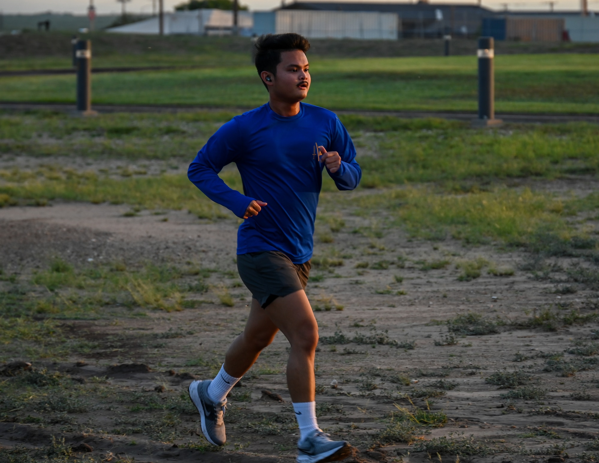 A participant in the 5K run challenge runs towards the finish line near the base track at Laughlin Air Force Base, Texas, May 19, 2026. The 5K run included 87 participants, with 68 runners finishing in under 40 minutes. (U.S. Air Force photo by Airman 1st Class Kylie Rabb)