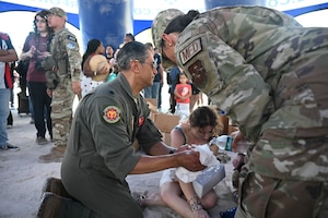 Lesser Antilles Medical Assistance Team members, Lt. Col. John “DRE” Beshai, commander and physician, 926th Aerospace Medicine Squadron, Nellis Air Force Base, Nevada, and Master Sgt. Yesenia Benjamin, superintendent, International Health Specialist Division, under the 12th Air Force (Air Forces Southern) Office of the Command Surgeon, headquartered at Davis-Monthan Air Force Base, Arizona, renders aid to a patron in need at the Hyundai Air and Sea Show, May 23, 2026, Miami, Florida. LAMAT, a team of Air Force medical professionals, joined Air Force Reserve recruiters, 351st Recruiting Squadron, Homestead Air Reserve Base, Florida, to share how to be an AFR medical professional or a part of the LAMAT mission that saves lives, but were called to duty during the air show to assist at a moment's notice. (U.S. Air Force photo by Master Sgt. Della Creech)