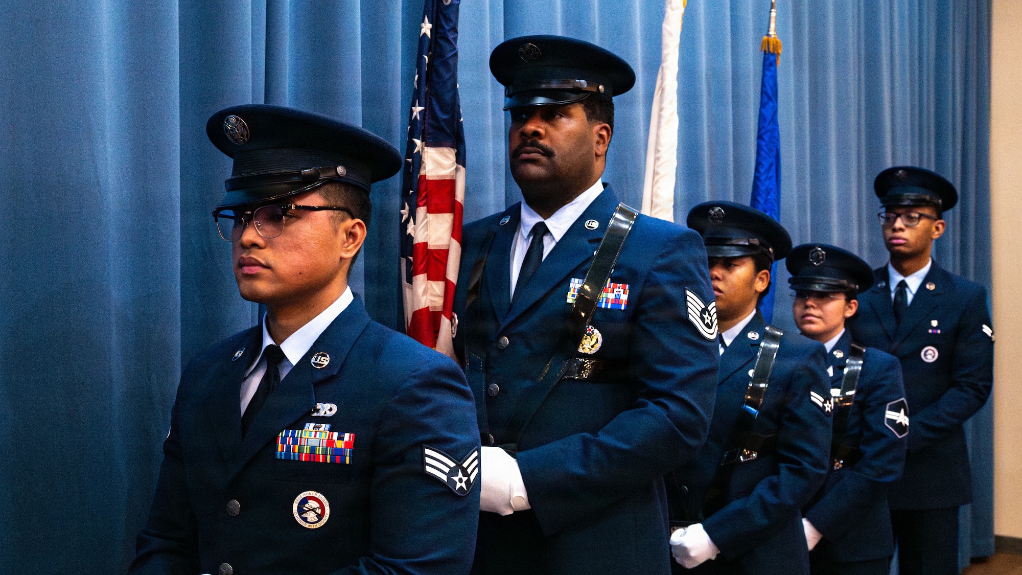 Honor guard members carry flags.