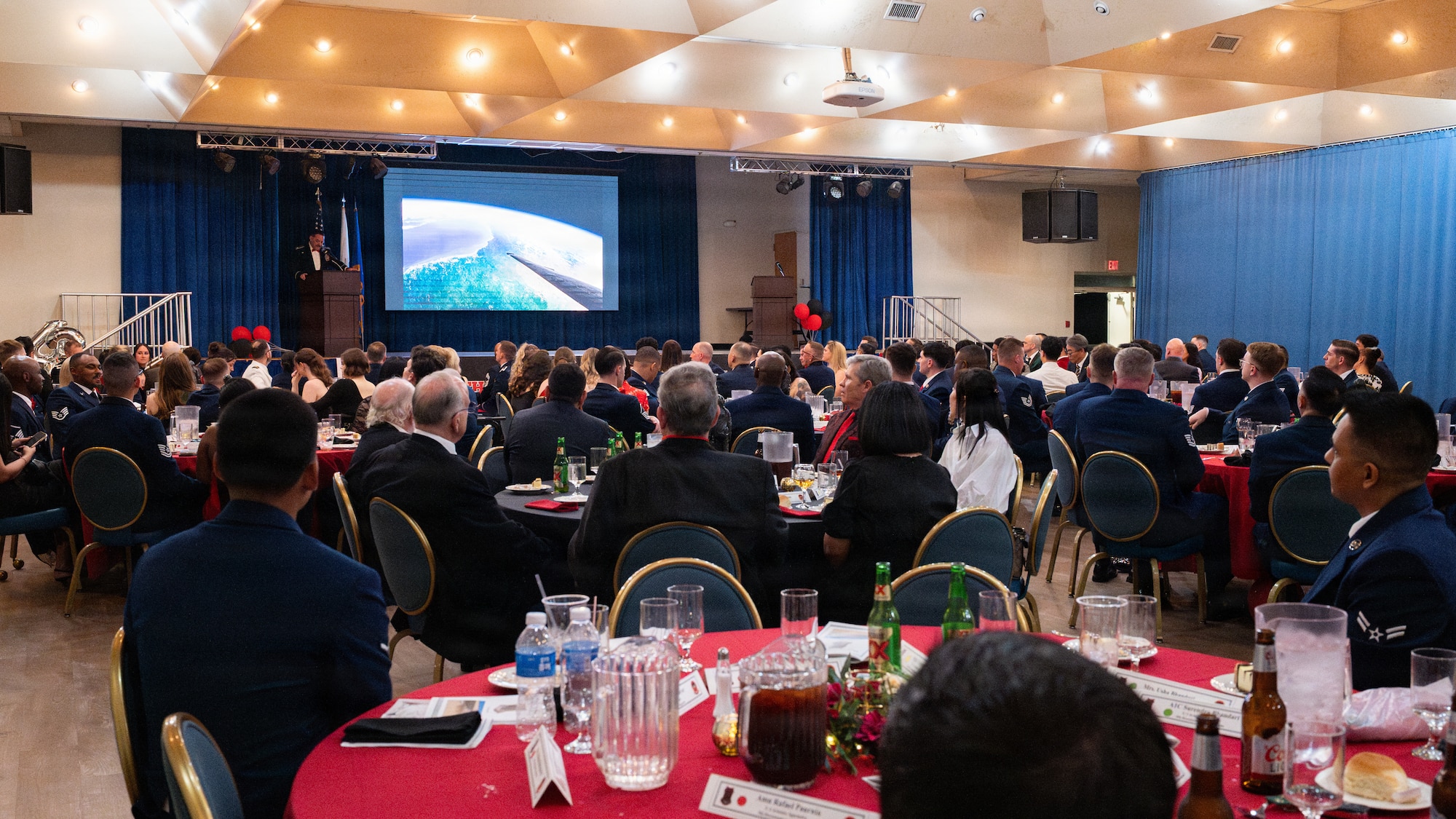 People listening to a speaker at a banquet.