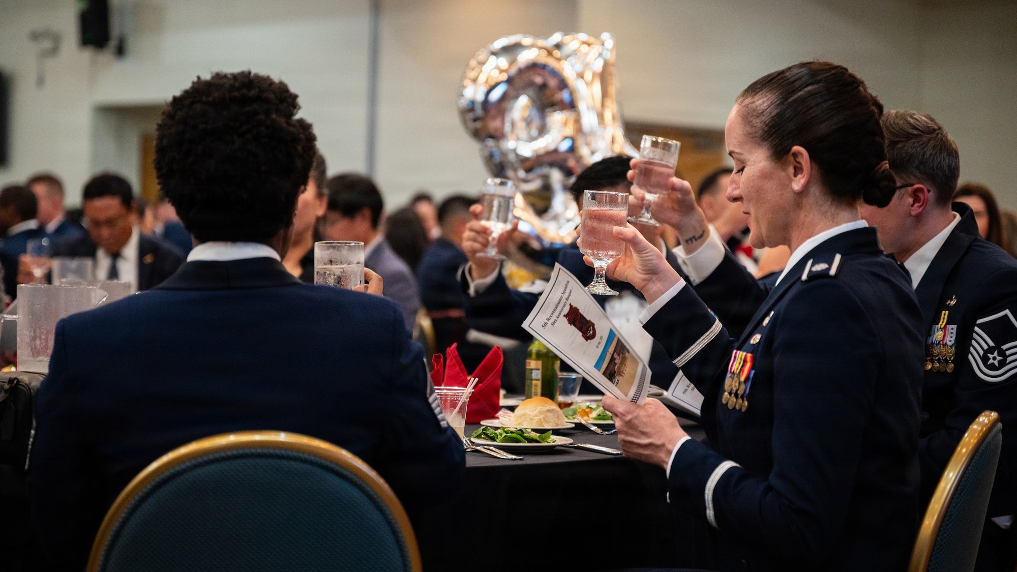 People delivering a toast with their glasses.