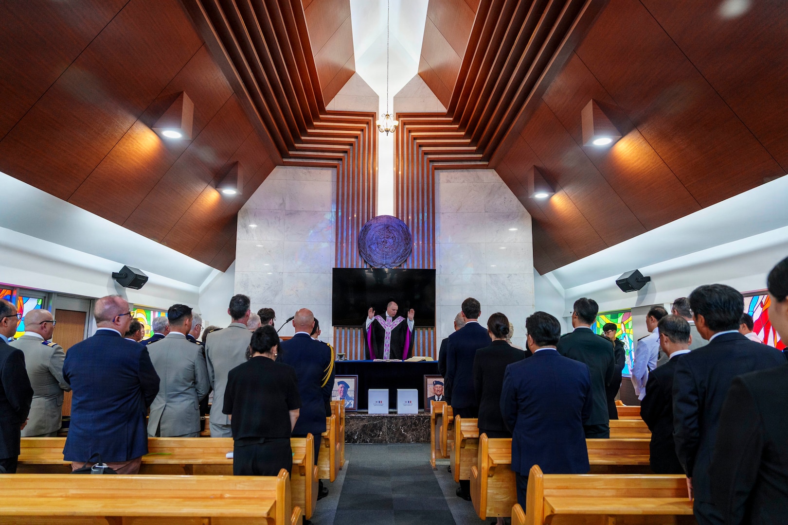 Maj. John F. Reutemann, deputy wing chaplain for the 51st Fighter Wing, leads a religious service during an interment ceremony for former French Korean War veterans André Datcharry and Jacques Grisolet at the United Nations Memorial Cemetery in Busan, South Korea, on May 27, 2026.