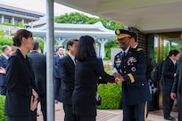 U.S. Army Gen. Xavier T. Brunson, commander of United Nations Command, Combined Forces Command, and U.S. Forces Korea, greets staff members at the United Nations Memorial Cemetery Korea before an interment ceremony for former French Korean War veterans André Datcharry and Jacques Grisolet in Busan, South Korea, on May 27, 2026.