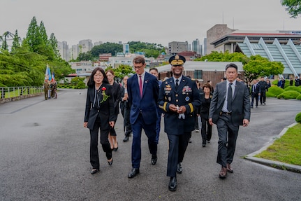 U.S. Army Gen. Xavier T. Brunson, commander of United Nations Command, Combined Forces Command, and U.S. Forces Korea, walks into the United Nations Memorial Cemetery in Korea with other attendees to participate in an interment ceremony for former French Korean War veterans André Datcharry and Jacques Grisolet in Busan, South Korea, on May 27, 2026. The event honors France’s sacrifices during the Korean War and recognizes its continued support to the United Nations Command.