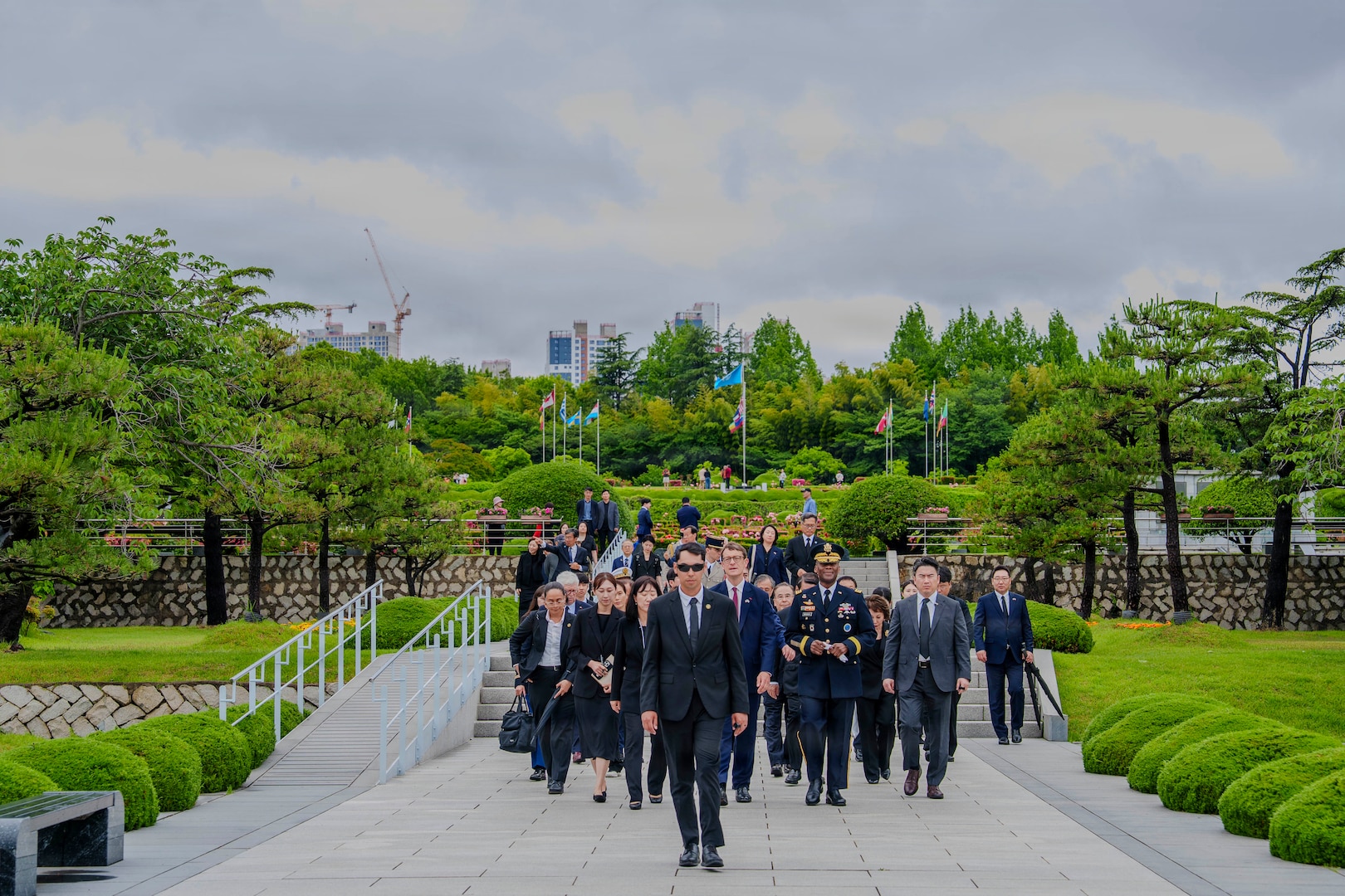 U.S. Army Gen. Xavier T. Brunson, commander of United Nations Command, Combined Forces Command, and U.S. Forces Korea, walks into the United Nations Memorial Cemetery Korea with other attendees to participate in an interment ceremony for former French Korean War veterans André Datcharry and Jacques Grisolet in Busan, South Korea, May 27, 2026. The ceremony honors France’s contributions and sacrifices during the Korean War and recognizes its continued support to the United Nations Command.