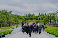 U.S. Army Gen. Xavier T. Brunson, commander of United Nations Command, Combined Forces Command, and U.S. Forces Korea, walks into the United Nations Memorial Cemetery Korea with other attendees to participate in an interment ceremony for former French Korean War veterans André Datcharry and Jacques Grisolet in Busan, South Korea, May 27, 2026. The ceremony honors France’s contributions and sacrifices during the Korean War and recognizes its continued support to the United Nations Command.