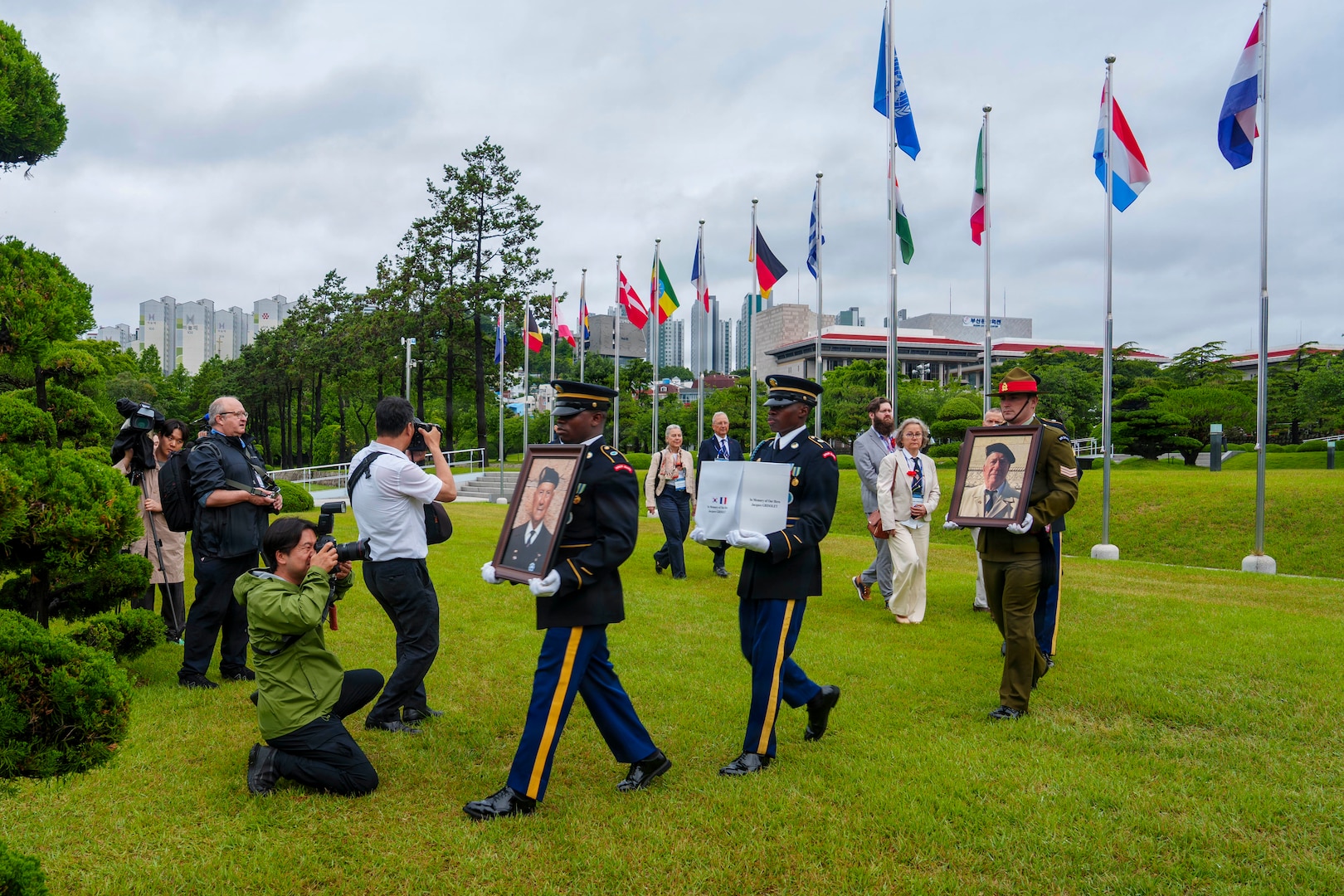 The United Nations Memorial Cemetery Korea Honor Guards delivers photos of former French Korean War veterans André Datcharry and Jacques Grisolet to their interment ceremony in Busan, South Korea, on May 27, 2026.