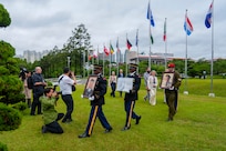 The United Nations Memorial Cemetery Korea Honor Guards delivers photos of former French Korean War veterans André Datcharry and Jacques Grisolet to their interment ceremony in Busan, South Korea, on May 27, 2026.