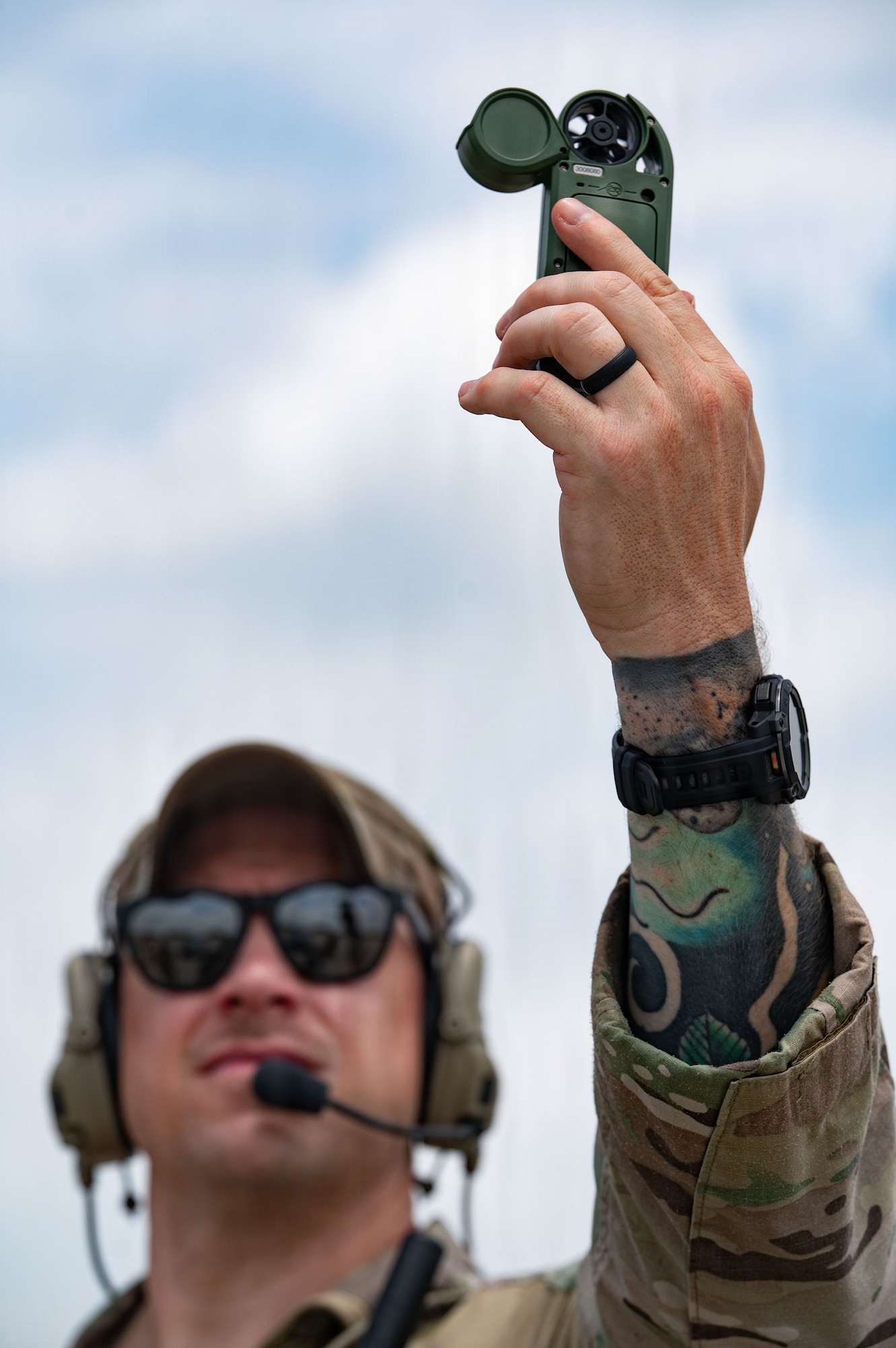 Airman uses wind meter.