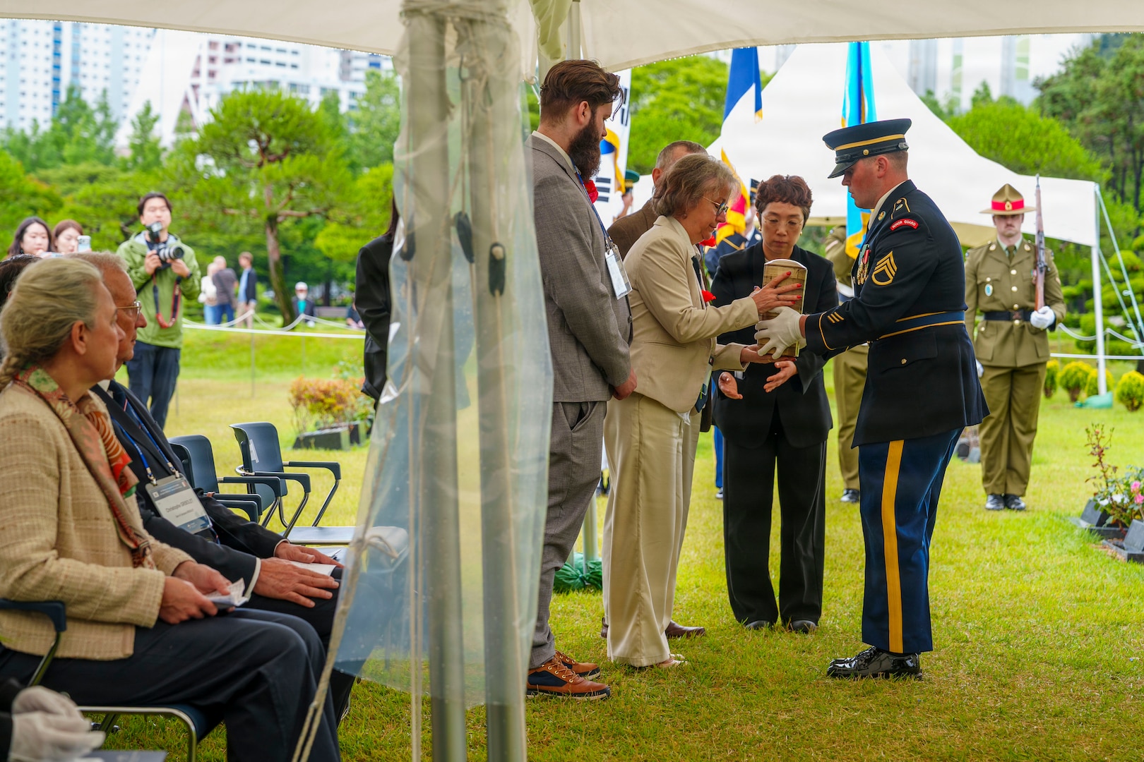 Staff at the United Nations Memorial Cemetery Korea deliver the remains of French Korean War veteran André Datcharry to his family during an interment ceremony honoring Datcharry and Jacques Grisolet in Busan, South Korea, on May 27, 2026.