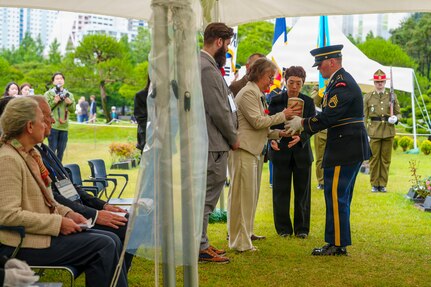 Staff at the United Nations Memorial Cemetery Korea deliver the remains of French Korean War veteran André Datcharry to his family during an interment ceremony honoring Datcharry and Jacques Grisolet in Busan, South Korea, on May 27, 2026.